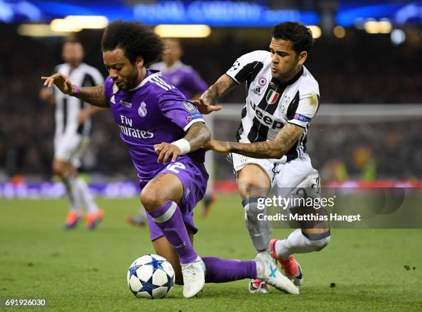 Marcelo of Real Madrid and Dani Alves of Juventus battle for possession during the UEFA Champions League Final between Juventus and Real Madrid at...