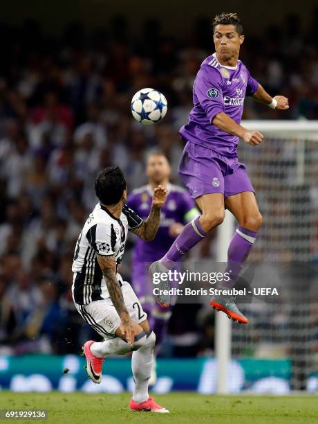 Cristiano Ronaldo of Real Madrid wins a header over Dani Alves of Juventus during the UEFA Champions League Final between Juventus and Real Madrid at...