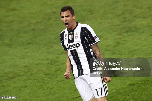 Mario Mandzukic of Juventus celebrates scoring his sides first goal during the UEFA Champions League Final between Juventus and Real Madrid at...