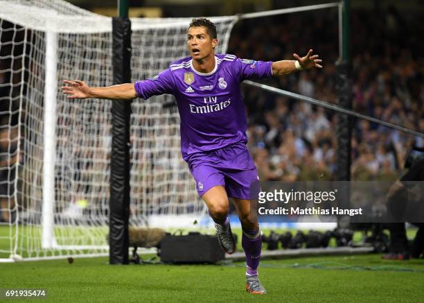 Cristiano Ronaldo of Real Madrid celebrates scoring his sides third goal during the UEFA Champions League Final between Juventus and Real Madrid at...