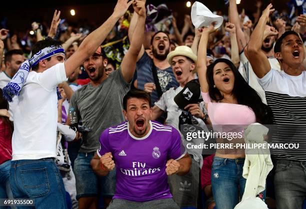 Real Madrid football team fans celebrate their team's second goal on the stands of the Santiago Bernabeu stadium in Madrid on June 3, 2017 during the...