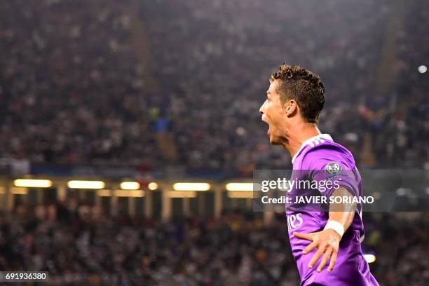 Real Madrid's Portuguese striker Cristiano Ronaldo celebrates after scoring their third goal during the UEFA Champions League final football match...