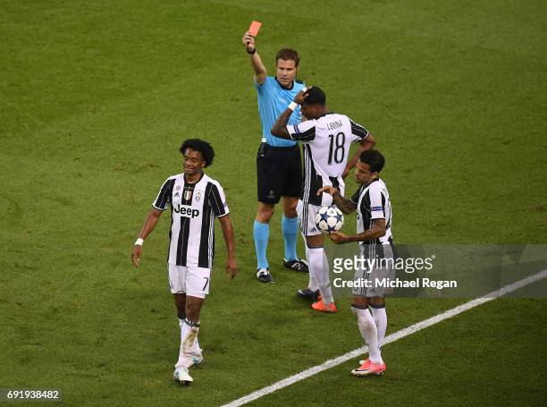 Juan Cuadrado of Juventus is shown a red card by referee Felix Brych during the UEFA Champions League Final between Juventus and Real Madrid at...