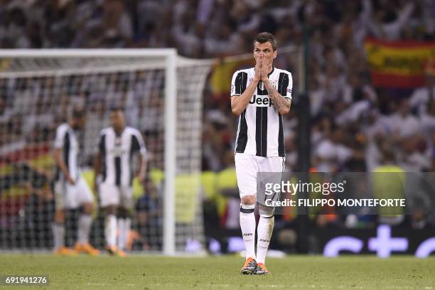 Juventus' Croatian striker Mario Mandzukic reacts after losing the UEFA Champions League final football match between Juventus and Real Madrid at The...