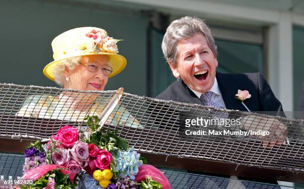 Queen Elizabeth II and her racing manager John Warren watch the racing as they attend Derby Day during the Investec Derby Festival at Epsom...