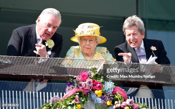 Lord Samuel Vestey, Queen Elizabeth II and John Warren watch the racing as they attend Derby Day during the Investec Derby Festival at Epsom...