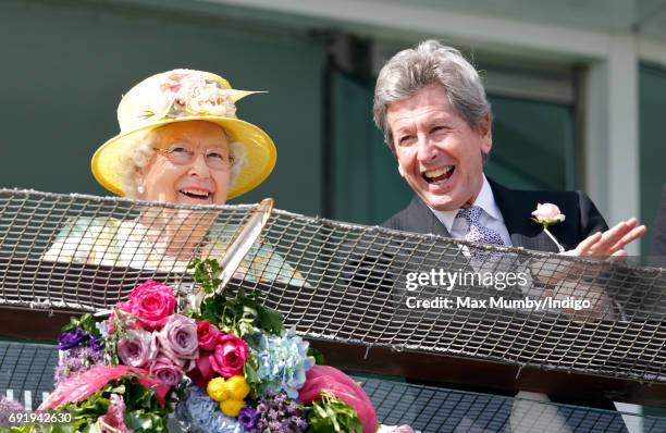 Queen Elizabeth II and her racing manager John Warren watch the racing as they attend Derby Day during the Investec Derby Festival at Epsom...