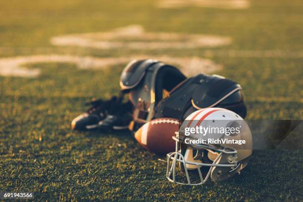 silver football helmet on field - ohio state football stock pictures, royalty-free photos & images