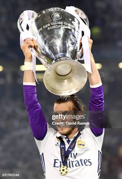 Gareth Bale of Real Madrid lifts The Champions League trophy after the UEFA Champions League Final between Juventus and Real Madrid at National...