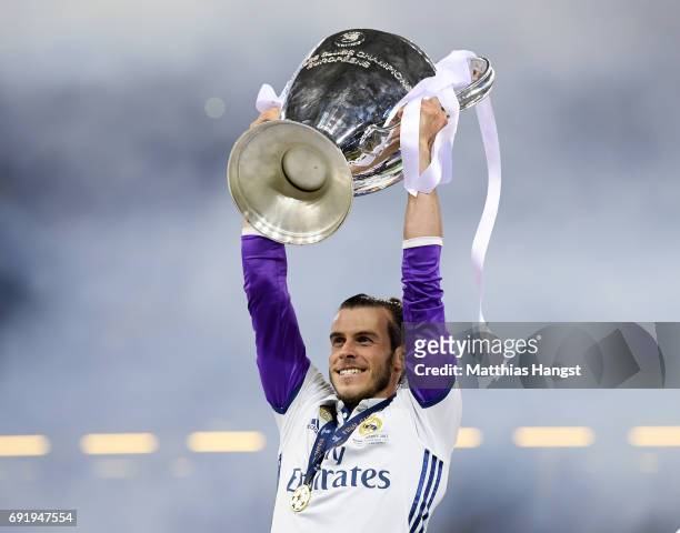 Gareth Bale of Real Madrid lifts The Champions League trophy after the UEFA Champions League Final between Juventus and Real Madrid at National...