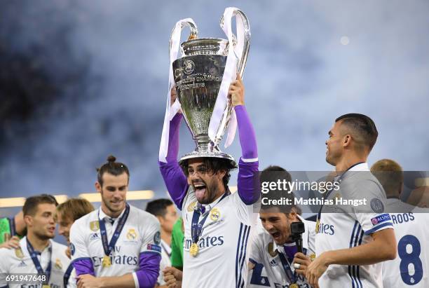 Isco of Real Madrid celebrates with The Champions League trophy after the UEFA Champions League Final between Juventus and Real Madrid at National...