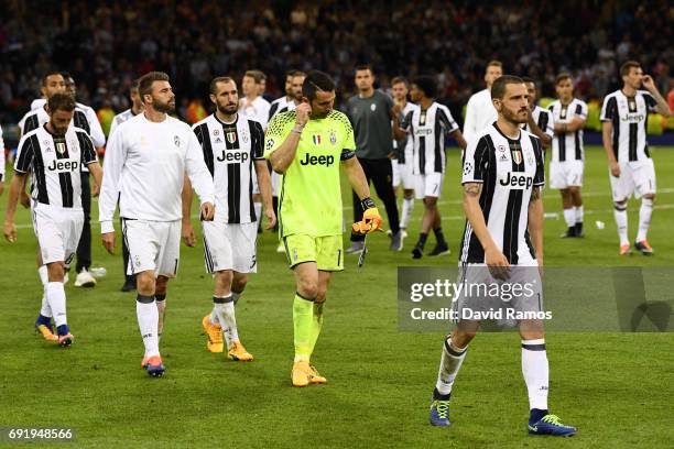 Gianluigi Buffon of Juventus and his team walk off dejected after the UEFA Champions League Final between Juventus and Real Madrid at National...