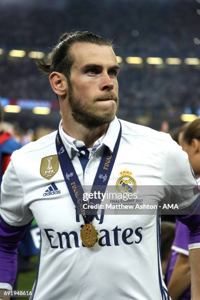Gareth Bale of Real Madrid looks on with his winners medal at the end of the UEFA Champions League Final between Juventus and Real Madrid at National...
