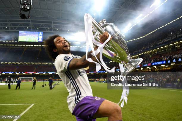 Marcelo of Real Madrid celebrates with The Champions League trophy after the UEFA Champions League Final between Juventus and Real Madrid at National...