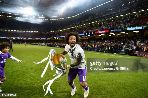 Marcelo of Real Madrid celebrates with The Champions League trophy after the UEFA Champions League Final between Juventus and Real Madrid at National...