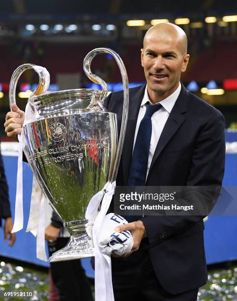 Zinedine Zidane, Manager of Real Madrid poses with the Champions League trophy after the UEFA Champions League Final between Juventus and Real Madrid...