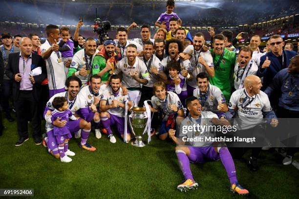 The Real Madrid team pose with the Champions League Trophy after the UEFA Champions League Final between Juventus and Real Madrid at National Stadium...