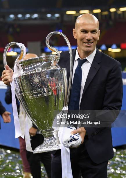 Zinedine Zidane, Manager of Real Madrid poses with the trophy after the UEFA Champions League Final between Juventus and Real Madrid at National...