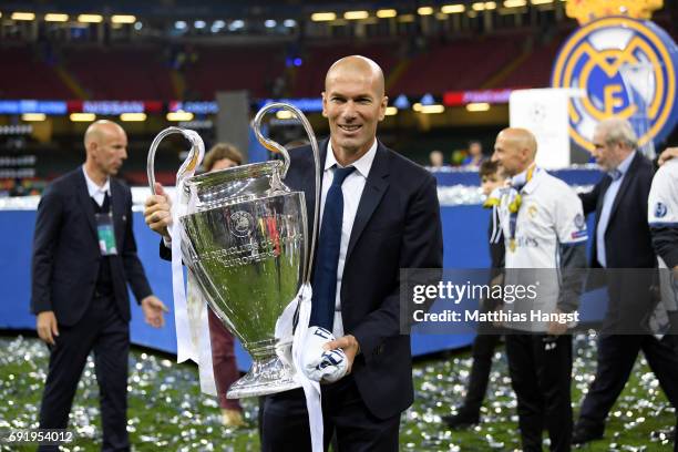 Zinedine Zidane, Manager of Real Madrid poses with the Champions League Trophy after the UEFA Champions League Final between Juventus and Real Madrid...