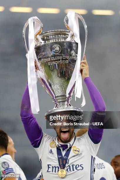 Isco of Real Madrid celebrates with The Champions League trophy after the UEFA Champions League Final between Juventus and Real Madrid at National...