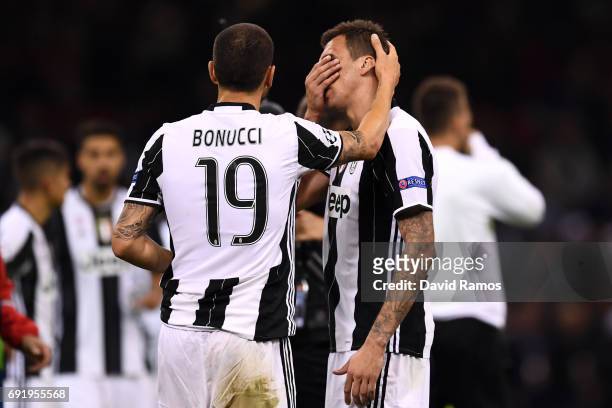 Leonardo Bonucci of Juventus and Mario Mandzukic of Juventus are dejected after the UEFA Champions League Final between Juventus and Real Madrid at...