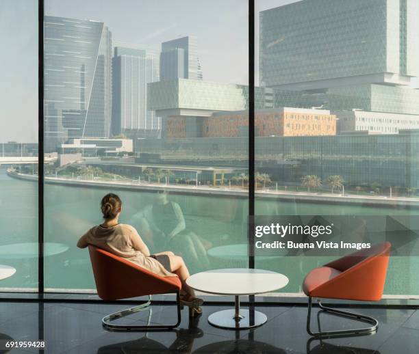 young woman watching futuristic city. - modern arab woman stockfoto's en -beelden