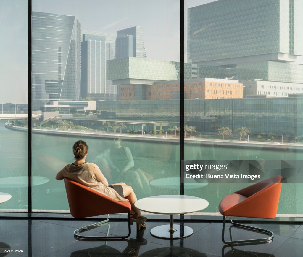 Young woman watching futuristic city.