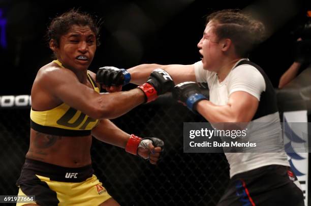 Jamie Moyle punches Viviane Pereira of Brazil in their womens strawweight bout during the UFC 212 event at Jeunesse Arena on June 3, 2017 in Rio de...