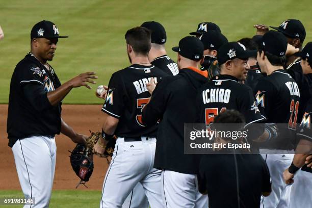 Edinson Volquez of the Miami Marlins gets the baseball from Justin Bour throwing a no hitter against the Arizona Diamondbacks at Marlins Park on June...