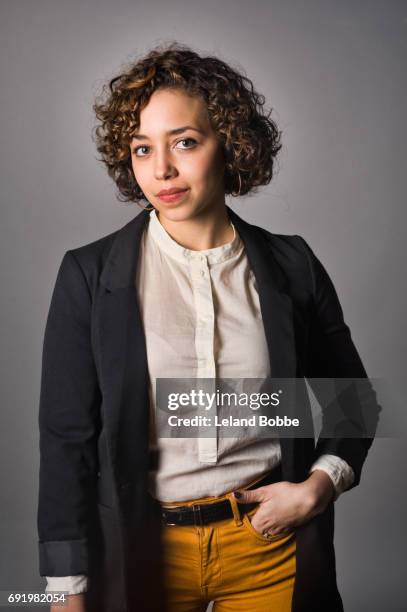portrait of young mixed race woman - hände in den taschen stock-fotos und bilder