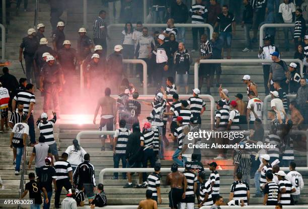 Policemen and fans are seen during the match between Corinthians and Santos for the Brasileirao Series A 2017 at Arena Corinthians stadium on June...