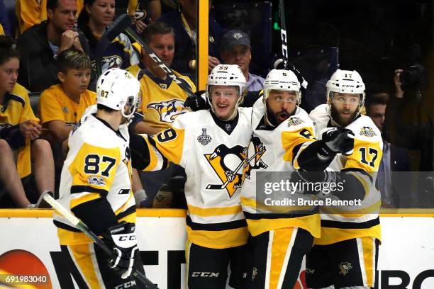 Jake Guentzel of the Pittsburgh Penguins celebrates with teammates after scoring a first-period goal against Pekka Rinne of the Nashville Predators...