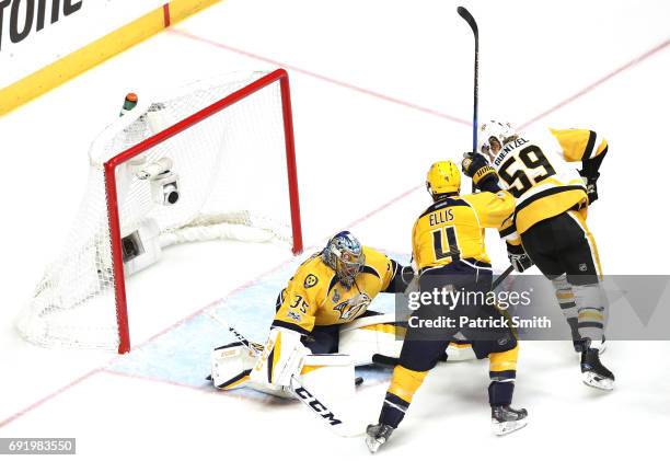 Jake Guentzel of the Pittsburgh Penguins scores a first period goal against Pekka Rinne of the Nashville Predators in Game Three of the 2017 NHL...