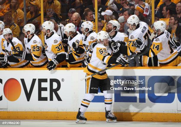 Jake Guentzel of the Pittsburgh Penguins is congratulated by teammates after his first period goal against the Nashville Predators in Game Three of...