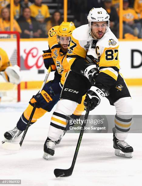 Sidney Crosby of the Pittsburgh Penguins controls the puck away from James Neal of the Nashville Predators during the first period of Game Three of...