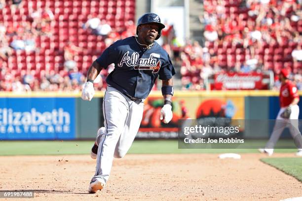 Adonis Garcia of the Atlanta Braves comes around to score a run after a single by Dansby Swanson in the fifth inning of a game against the Cincinnati...