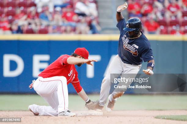 Adonis Garcia of the Atlanta Braves steals second base ahead of the throw to Jose Peraza of the Cincinnati Reds in the 12th inning of a game at Great...