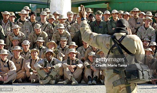 Marine Lance Cpl. Marcus Miller prepares to photograph members of the Marine Air Combat Element at the American military compound at Kandahar Airport...