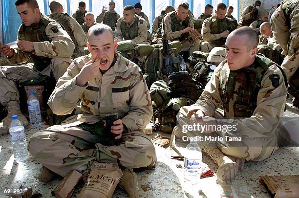 Army 101st Airborne Division Pvt. Thomas Kevin of Belpre, Ohio and Pfc. John Meck of Susquehanna, Pennsylvania eat lunch during their first day at...