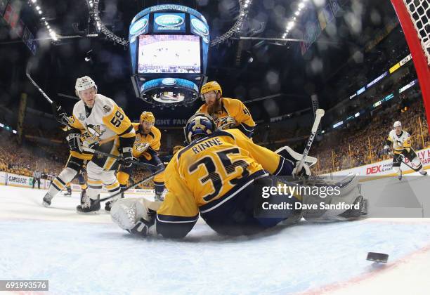 Jake Guentzel of the Pittsburgh Penguins watches the puck get past goaltender Pekka Rinne of the Nashville Predators for a goal in the first period...