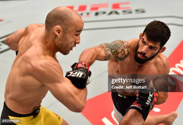 Raphael Assuncao of Brazil punches Marlon Moraes in their bantamweight bout during the UFC 212 event at Jeunesse Arena on June 3, 2017 in Rio de...