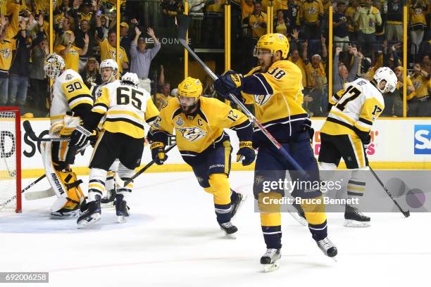 Viktor Arvidsson of the Nashville Predators celebrates after James Neal of the Nashville Predators , scored a second period goal against Matt Murray...