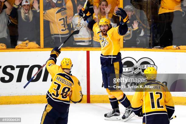 James Neal of the Nashville Predators celebrates with teammates after scoring a second period goal against Matt Murray of the Pittsburgh Penguins in...