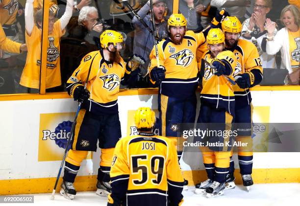 James Neal of the Nashville Predators celebrates with teammates after scoring a second period goal against Matt Murray of the Pittsburgh Penguins in...