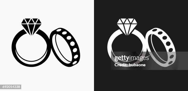 wedding rings icon on black and white vector backgrounds - engagement ring clipart stock illustrations