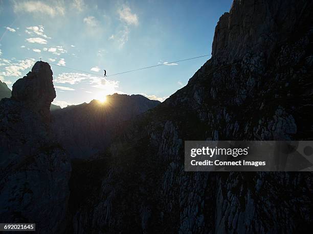 highline walker balancing on tightrope, innsbruck, tyrol, austria - tirol austria stock pictures, royalty-free photos & images