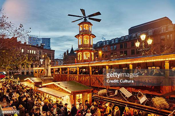 christmas market illuminated at night, albert square, manchester, uk - manchester england stock pictures, royalty-free photos & images