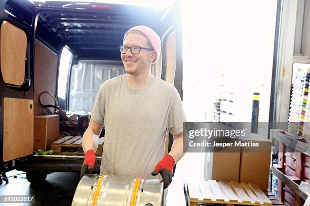 worker in brewery, preparing to distribute barrels of beer - microbrewery stock pictures, royalty-free photos & images