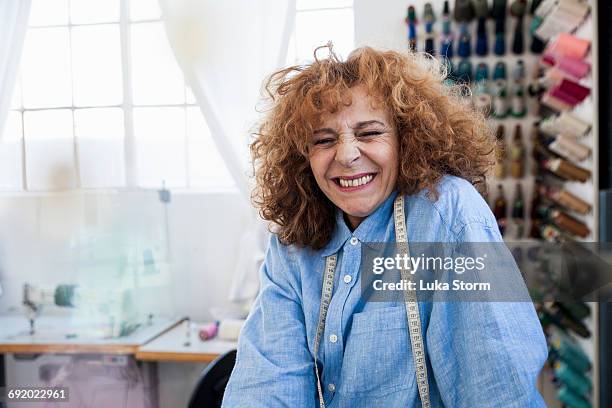 seamstress looking at camera smiling - fashion designer sewing stock pictures, royalty-free photos & images