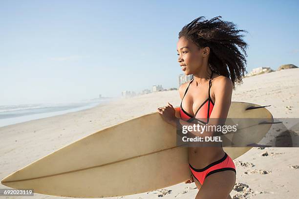 beautiful young female surfer running on beach, cape town, western cape, south africa - carrying water stock pictures, royalty-free photos & images